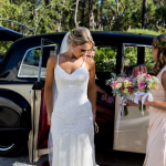 bride with classic wedding car