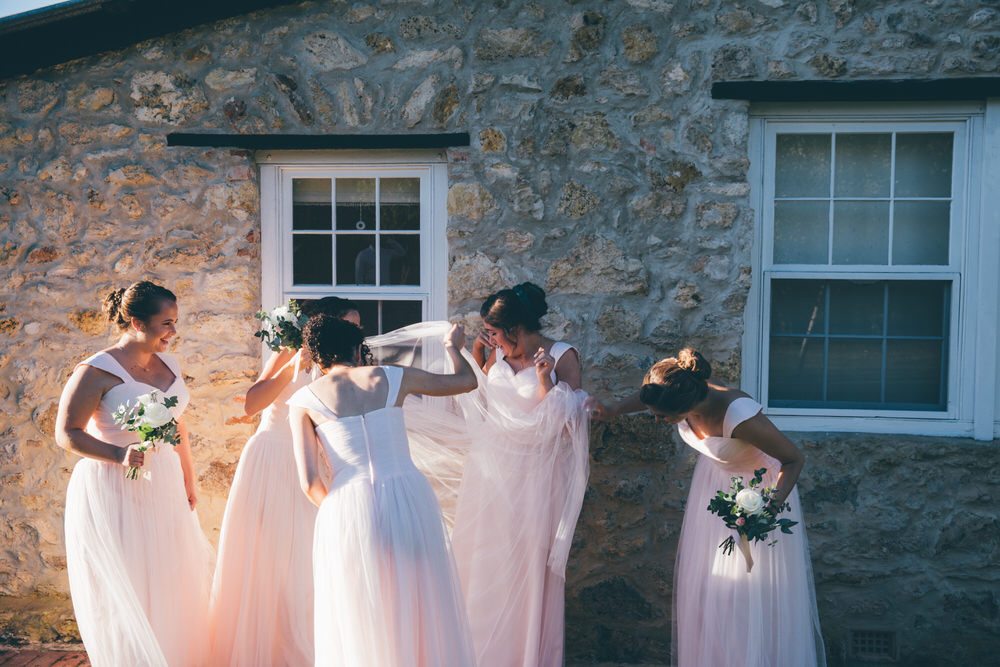 bridesmaids in front of stone cottage
