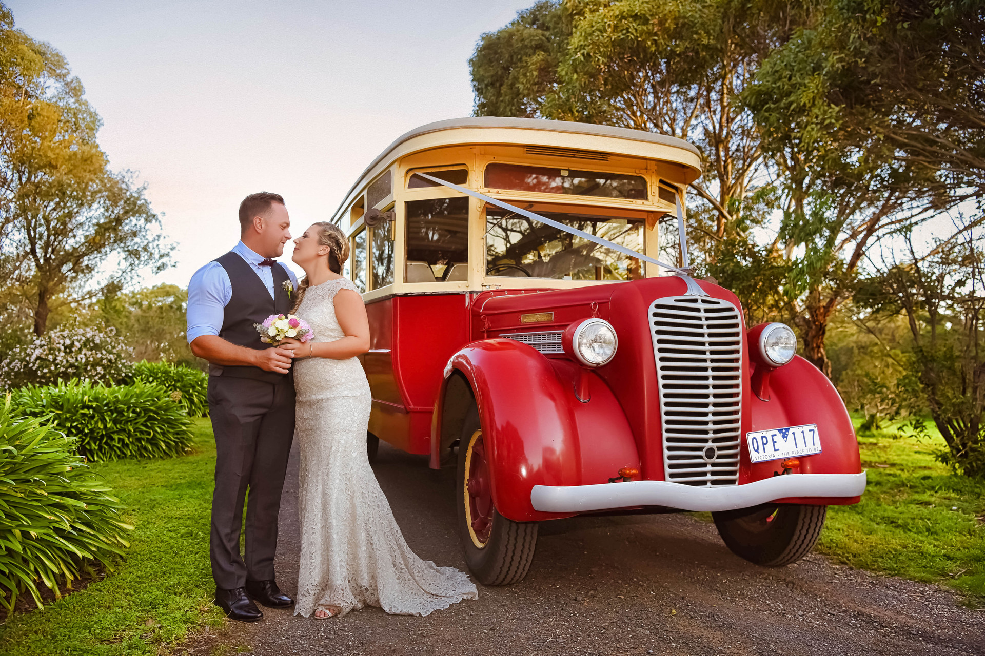 bride and groom with wedding bus