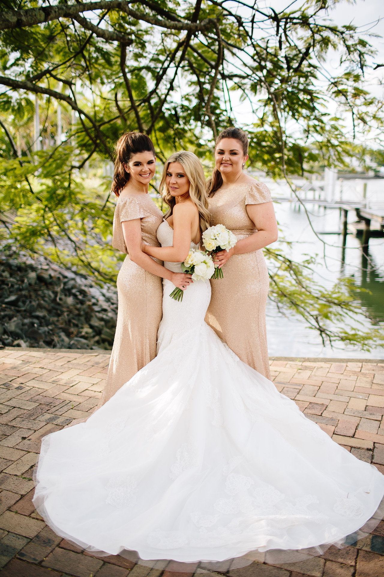 bride in stunning wedding dress with her bridesmaids