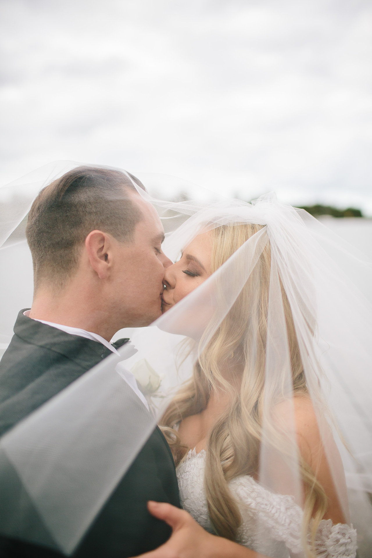 bride and groom share a kiss
