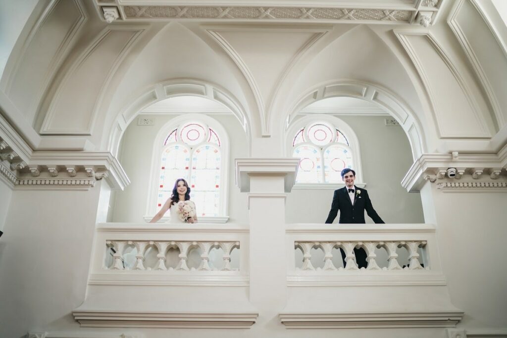 Sophia and Kyle pose on their wedding venue's mezzanine balcony.